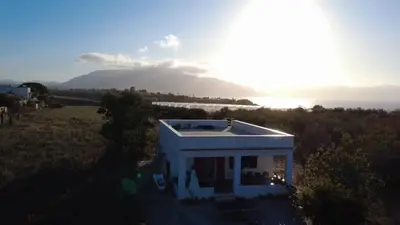 a white house with a view of the water at Villetta indipendente a Balestrate in Balestrate