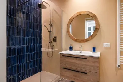 a bathroom with a sink and a shower at Constance Luxury Apartment by DomuSicily in Palermo