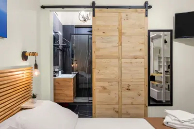 a bedroom with a sliding door leading to a bathroom at Al Borghetto marinaro in Palermo