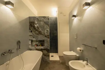a bathroom with a tub and a toilet and a sink at Le radici di Gallidoro in Palermo
