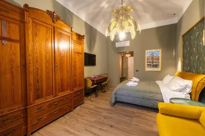 a bedroom with a bed and a desk at Le radici di Gallidoro in Palermo