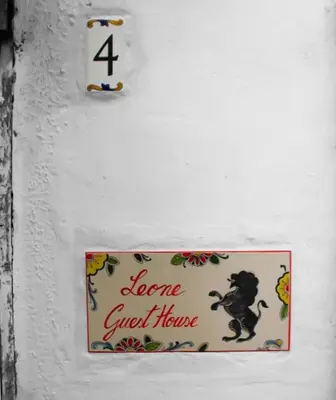 a sign that says done great house on a wall at Leone Guest House in Palermo