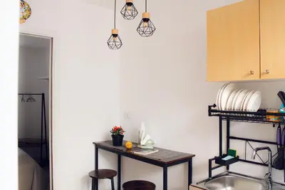 a kitchen with a small table and some lights at Leone Guest House in Palermo