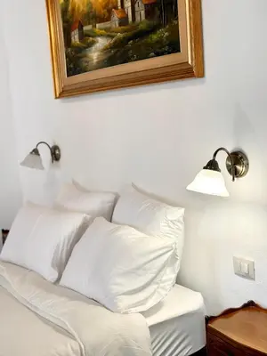 a bedroom with a bed and a chandelier at Kalsa Baroque Apartment in Palermo