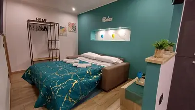 a bedroom with a bed with a blue wall at Sogni d'oro in Partinico