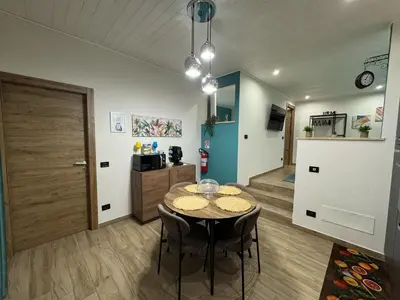 a kitchen and dining room with a table and chairs at Sogni d'oro in Partinico