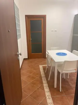 a dining room with a white table and chairs at Vittorosa House in Palermo