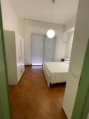 a bedroom with a bed and a large mirror at Vittorosa House in Palermo