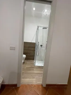 a bathroom with a shower and a toilet at Vittorosa House in Palermo