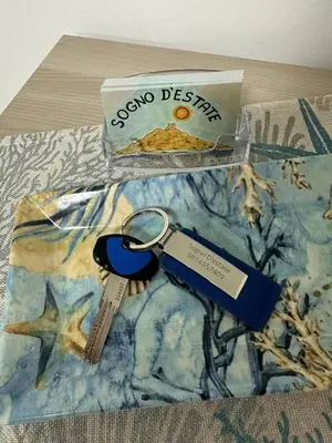 a pair of keys sitting on top of a bed at Sogno d'estate in Isola delle Femmine