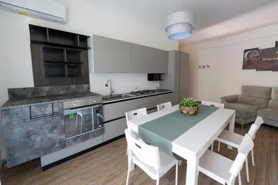 a kitchen and dining room with a table and chairs at Oltre il Mare Trabia in Trabia