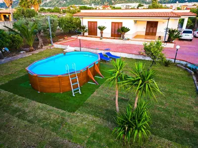 a swimming pool in a yard with a house at Casa Vacanze Caruso in Carini