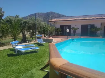 a large swimming pool in front of a house at Casa Vacanze Caruso in Carini