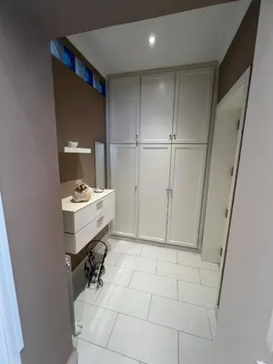 a bathroom with white cabinets and a white tile floor at Casa delle Stelle in Mondello