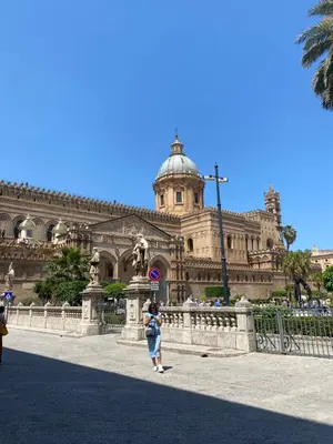 a woman taking a picture of a building at Barù home in centro in Palermo