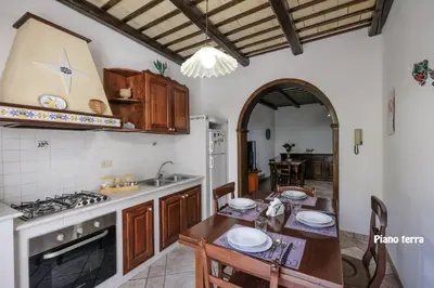a kitchen with a table and a counter top at Appartamenti Esther in San Vito lo Capo