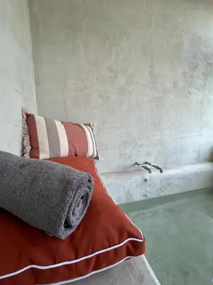 a bed with a red blanket and pillows on it at Palazzo Crisafulli 1- casa Liberty con vasca esterna in Palermo