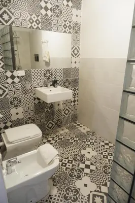 a bathroom with a toilet and a sink at Palazzo Crisafulli 1- casa Liberty con vasca esterna in Palermo