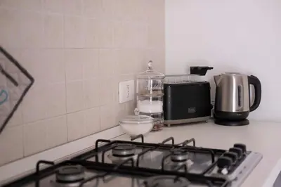 a stove top oven with a coffee maker and a blender at Cefalù, Lascari - Appartamento moderno vicino al mare in Lascari
