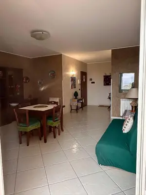 a living room with a table and a couch at Anna&Micky town house in Santa Flavia