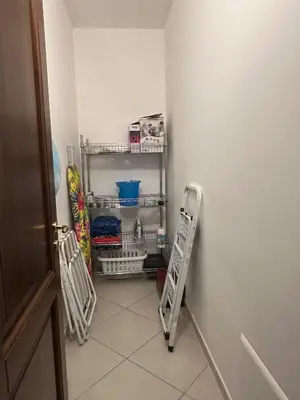 a hallway with a towel rack next to a wall at Anna&Micky town house in Santa Flavia