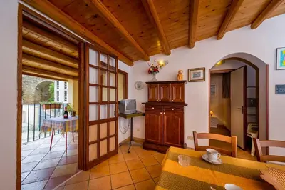 a living room with a table and a dining room at Le Scalette in Castellammare del Golfo