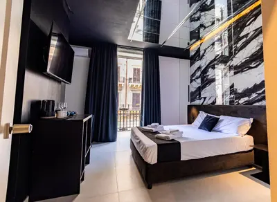 a bedroom with a bed and a large window at Amari120Suite&Spa in Palermo