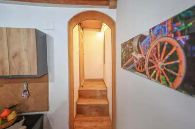 a hallway with a stairway with a painting on the wall at La Casa di Sughero in Palermo