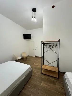 a white room with a bed and a mirror at Casa Bedda - INTERA CASA CON 3 CAMERE CON BAGNO PRIVATO, ARIA CONDIZIONATA E NO ZTL/ENTIRE APARTMENT WITH 3 BEDROOMS WITH PRIVATE BATHROOM, AIRCON AND NO LTZ in Castellammare del Golfo