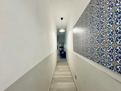 a hallway with blue and white tiles on the wall at Angelia in Capaci