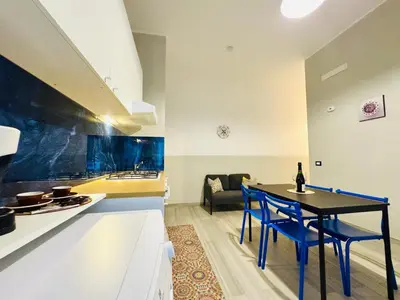 a kitchen and living room with a table and chairs at Angelia in Capaci