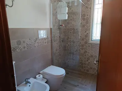 a bathroom with a toilet and a sink at Le Tremar Carini Poseidon in Carini