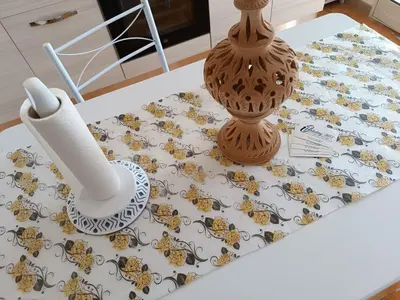 a table with a table cloth with a vase on it at Le Tremar Carini Poseidon in Carini