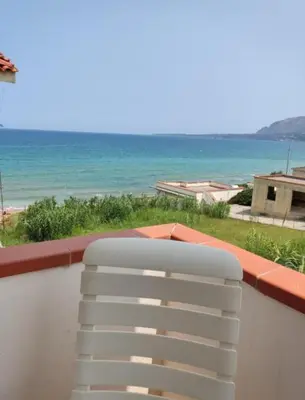 a white chair on a balcony with a view of the ocean at Sizilien 2 in Trappeto