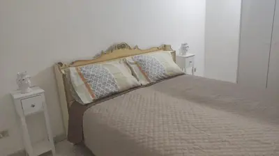 a bedroom with a bed with two night stands at Sizilien 2 in Trappeto