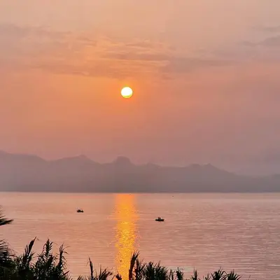 a sunset over the water with boats in it at Sizilien 2 in Trappeto