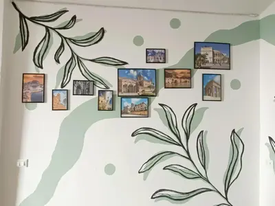 a wall mural of a plant with pictures on it at appartamento centro storico - La casuzza alla Cala in Palermo