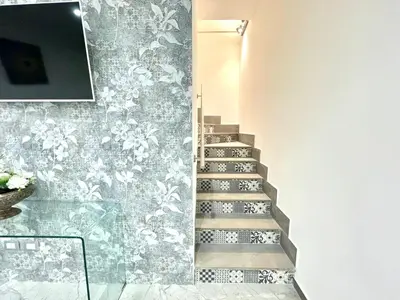 a stairway with a mural of flowers on a wall at Nel Cuore di Palermo Isidoro Palace in Palermo