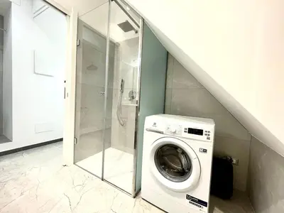 a washer and dryer in a bathroom with a staircase at Nel Cuore di Palermo Isidoro Palace in Palermo