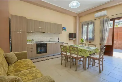 a kitchen and dining room with a table and chairs at Casa Maria Stella Scopello in Scopello
