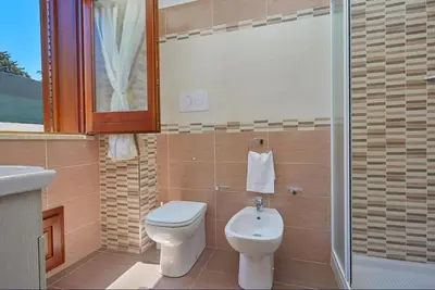 a bathroom with a toilet and a sink and a shower at Casa Maria Stella Scopello in Scopello