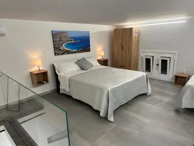 a bedroom with a bed and a glass floor at Vespro House in Palermo