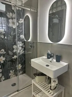 a bathroom with a sink and a shower at Vespro House in Palermo