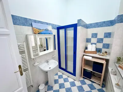 a bathroom with a sink and a mirror at Da Cosimo U pitturi in Palermo