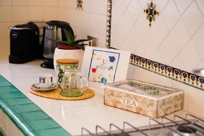 a kitchen counter with a tea set and a box at Da Cosimo U pitturi in Palermo