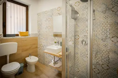 a bathroom with a shower and a toilet and a sink at Scalini holiday in Castellammare del Golfo