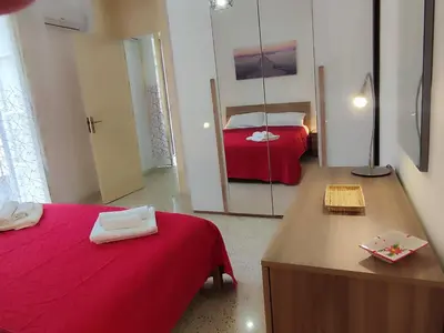 a small room with two beds and a mirror at Politeama my Suite in Palermo