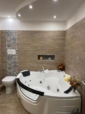 a bathroom with a white tub and a toilet at Ninohouse in Palermo