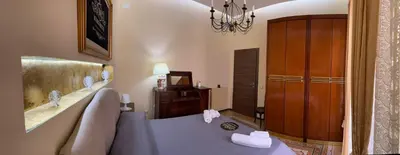 a bedroom with a bed and a chandelier at Ninohouse in Palermo