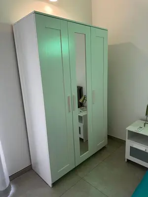 a large green cabinet in a room with a desk at Il falchetto in Palermo